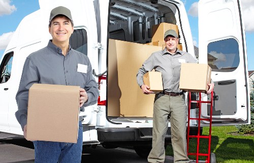 Local moving team loading furniture into a van